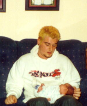 Greg holding Hailey on Grandma's couch