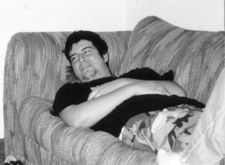 Picture of Greg lying on the couch taking it easy